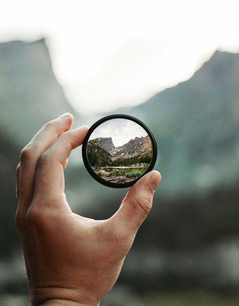 A stunning mountain landscape magnified through a handheld lens highlighting exploration and adventure.
