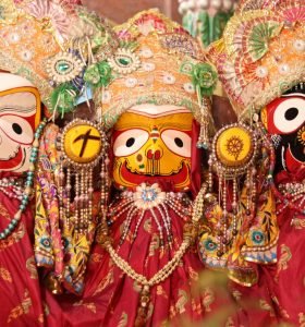 Vibrant and ornate depiction of Hindu deities at Ratha Yatra festival in India.